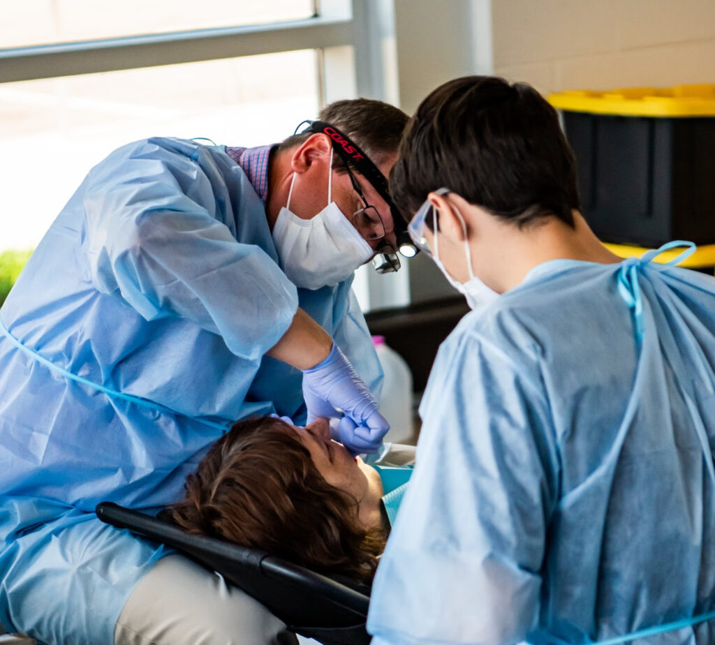 Wisconsin Dentist, Tom Onjukka, Taking Care of a Patient at the Free